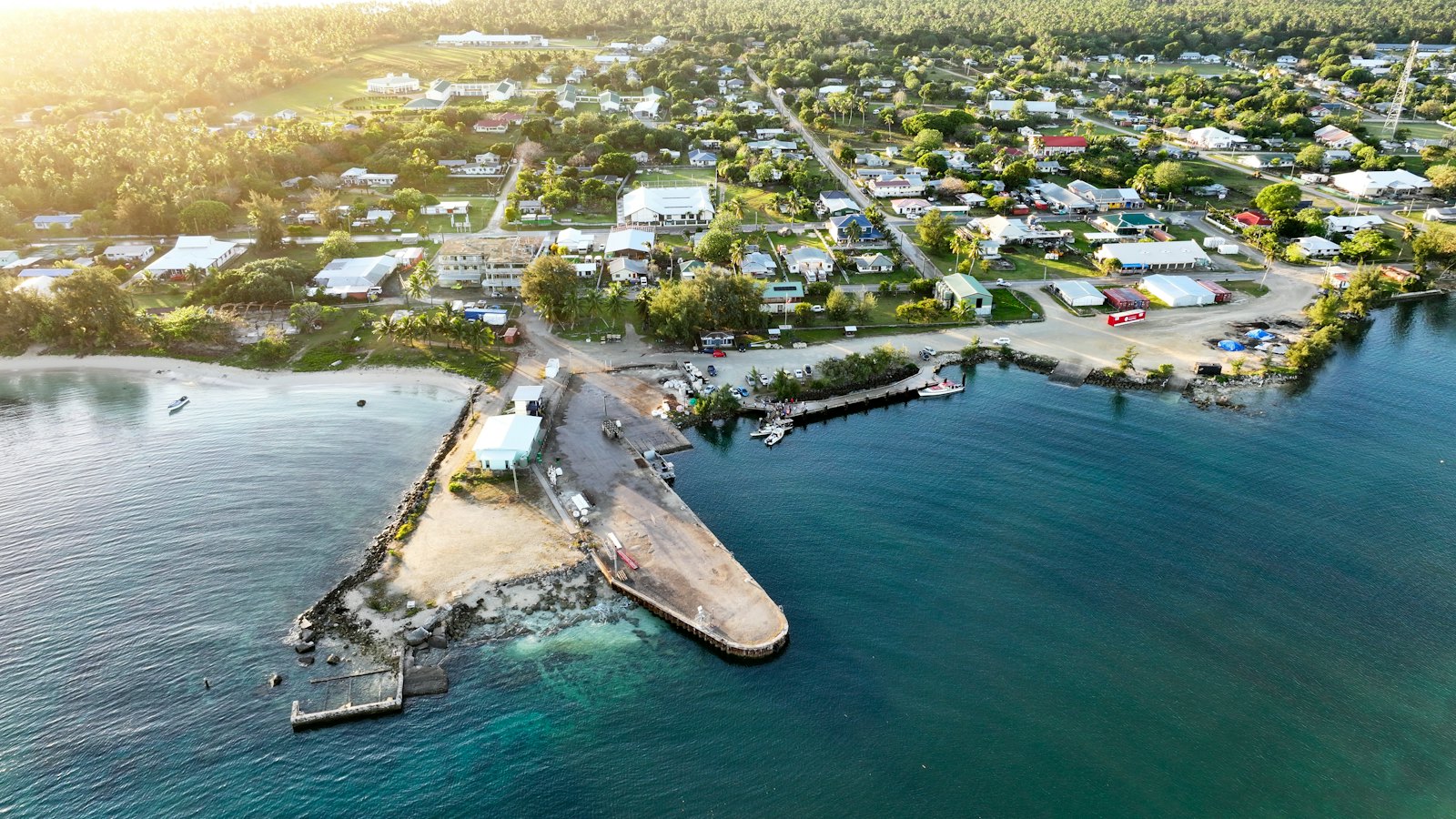 An island coastline and harbour seen from the air